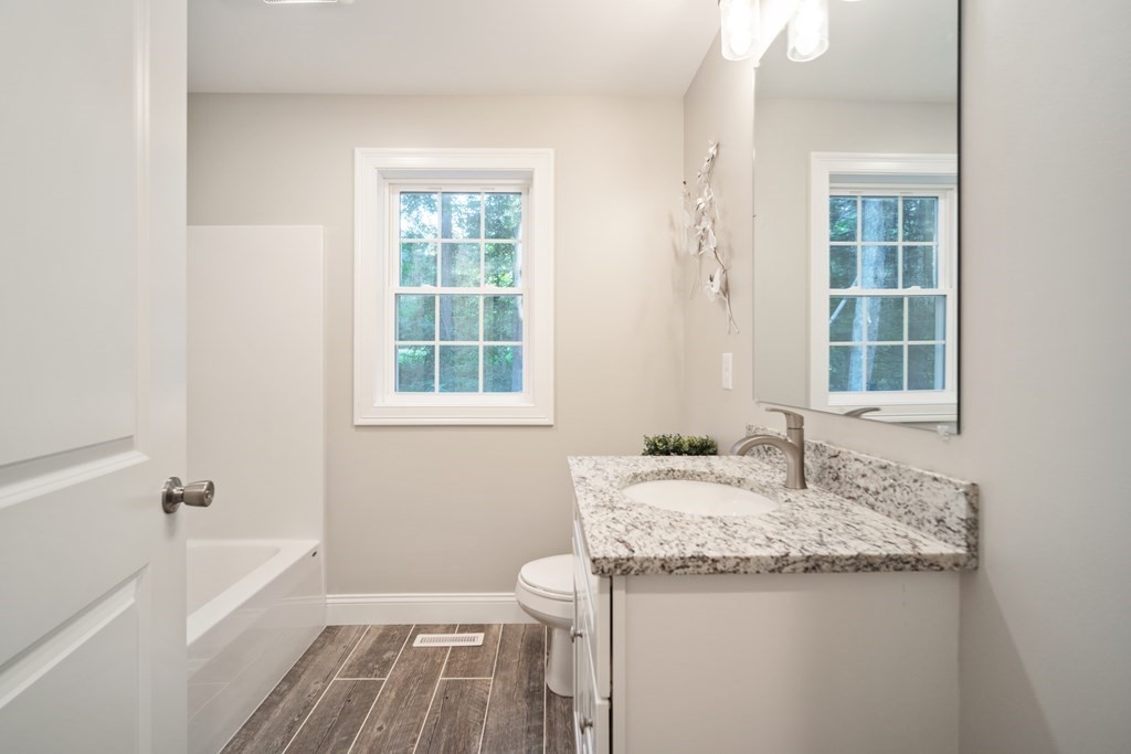 245 Glendale Road Northampton, MA 01062 - Photo 27 of 36 a bathroom with a granite countertop sink and a bathtub