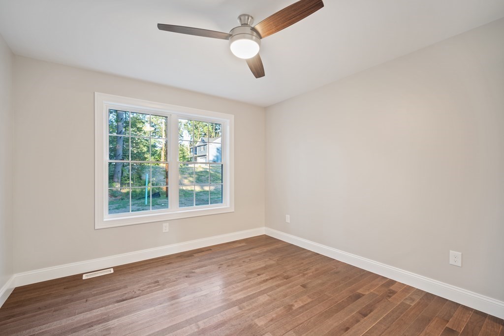 245 Glendale Road Northampton, MA 01062 - Photo 31 of 36 an empty room with wooden floor ceiling fan and window