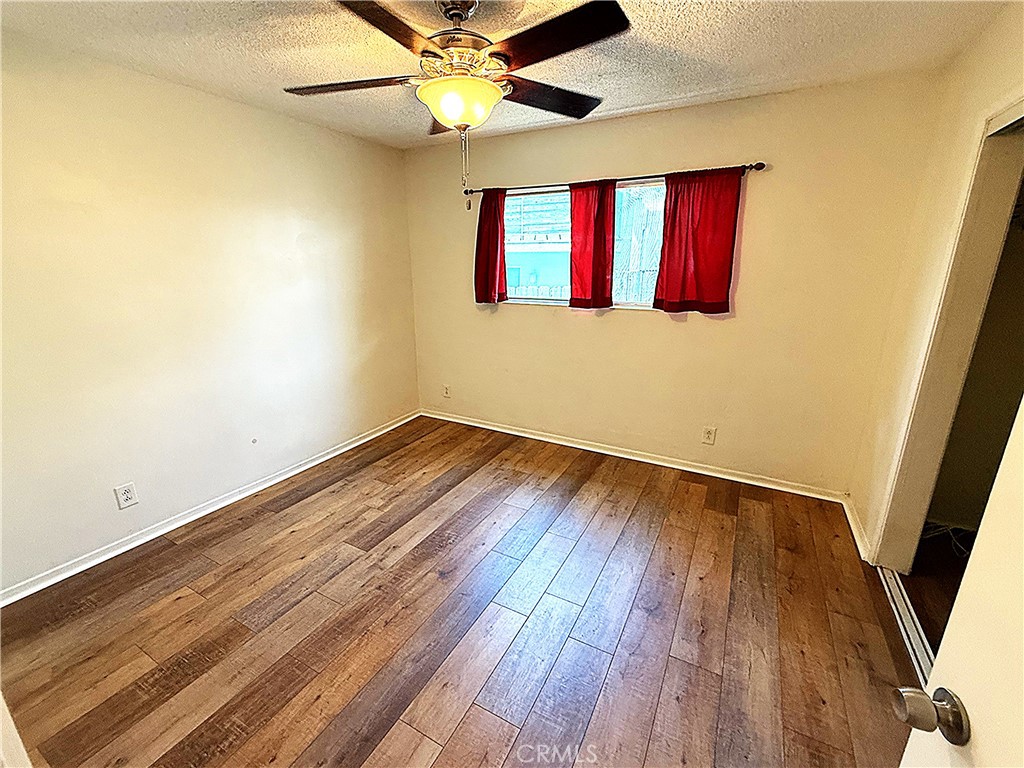 6652 Valmont Street Tujunga, CA 91042 - Photo 11 of 16 wooden floor in an empty room with a window