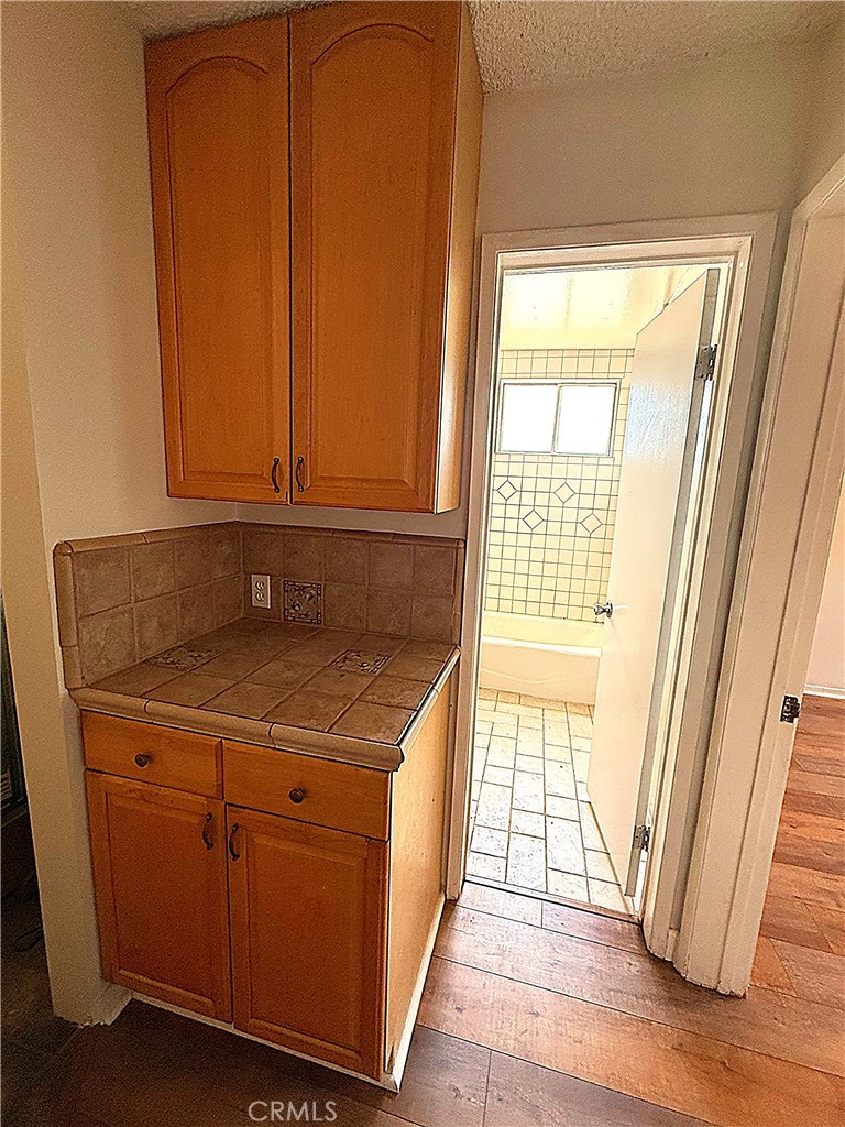 6652 Valmont Street Tujunga, CA 91042 - Photo 14 of 16 a utility room with wooden floor washer and dryer
