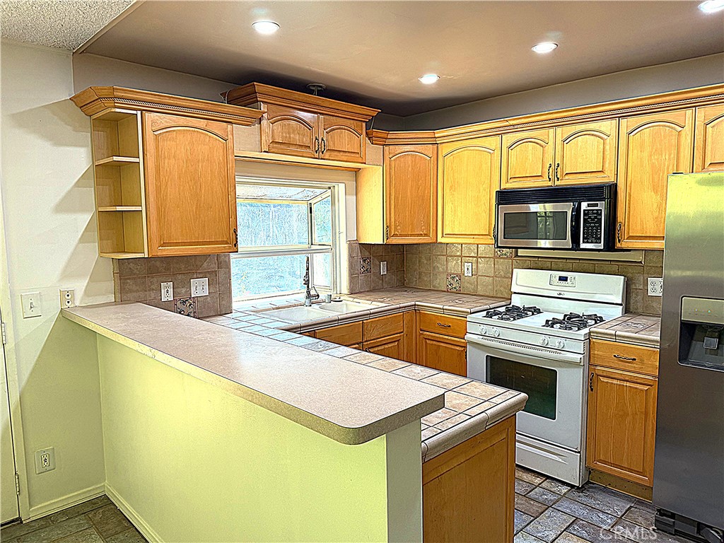 6652 Valmont Street Tujunga, CA 91042 - Photo 3 of 16 a kitchen that has a sink and a stove top oven