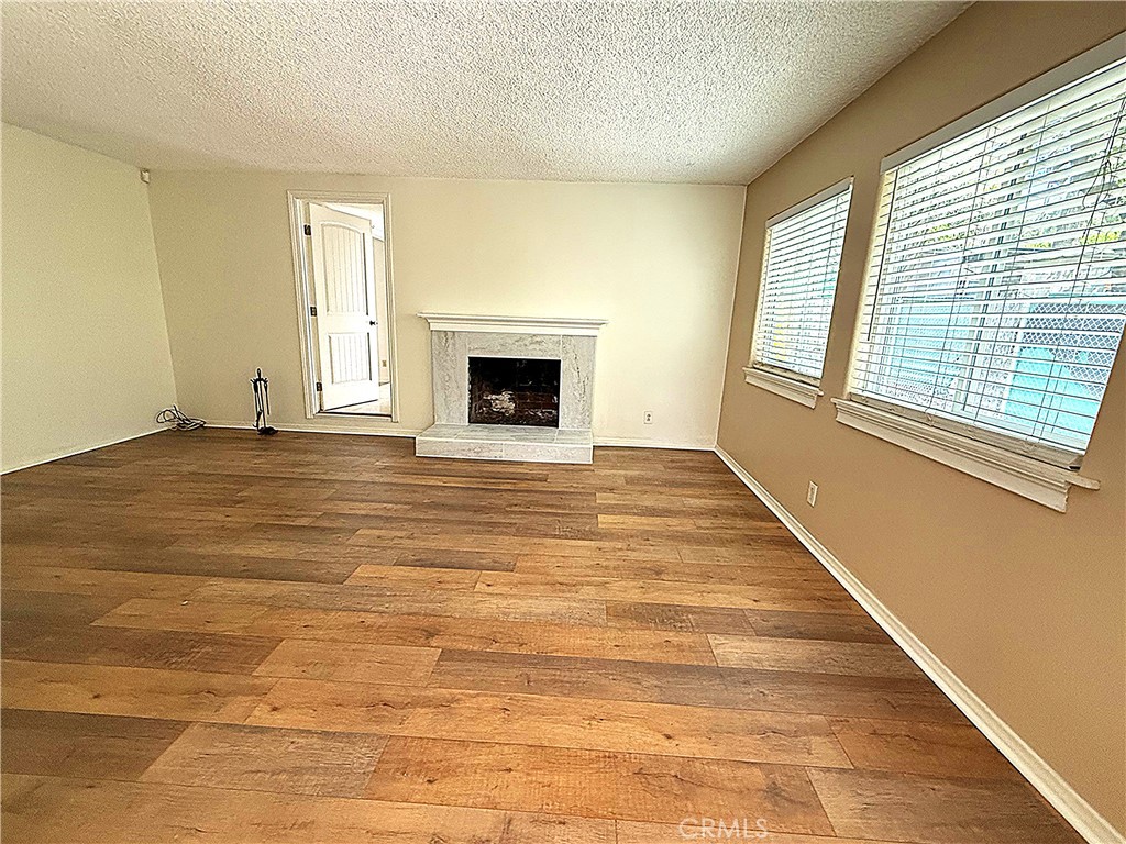 6652 Valmont Street Tujunga, CA 91042 - Photo 6 of 16 a view of an empty room with a fireplace and a window