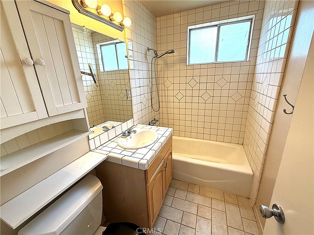 6652 Valmont Street Tujunga, CA 91042 - Photo 9 of 16 a bathroom with a sink a bathtub and shower