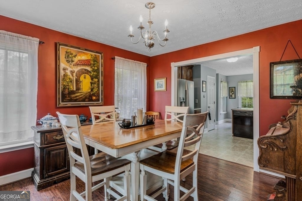 80 Upper Caldwell Road Bowdon, GA 30108 - Photo 12 of 33 a view of a dining room with furniture window and wooden floor