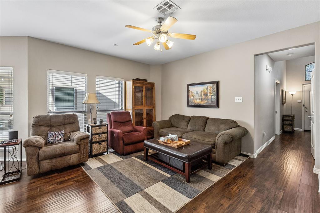 5500 Conch Train Road McKinney, TX 75070 - Photo 11 of 34 a living room with furniture a rug and a chandelier