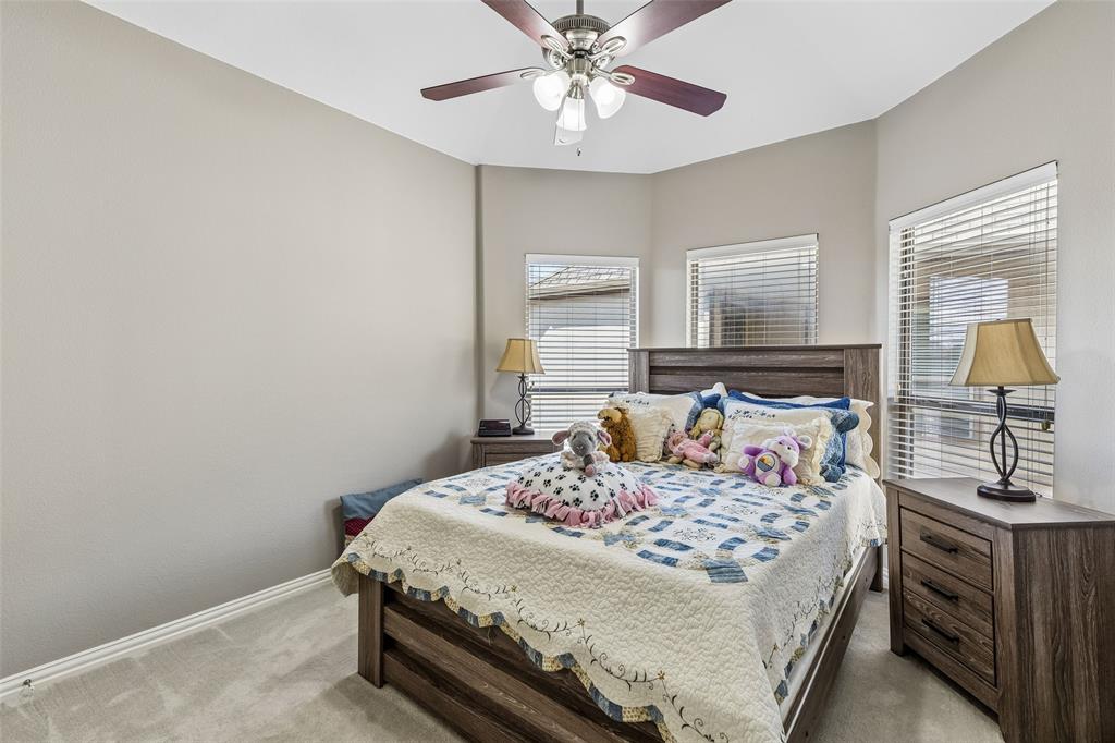 5500 Conch Train Road McKinney, TX 75070 - Photo 17 of 34 a bedroom with a bed and a chandelier