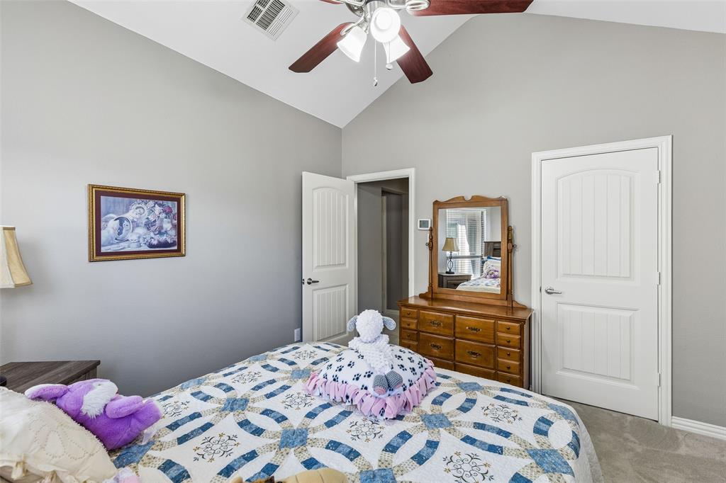 5500 Conch Train Road McKinney, TX 75070 - Photo 18 of 34 a bedroom with a bed and a chandelier