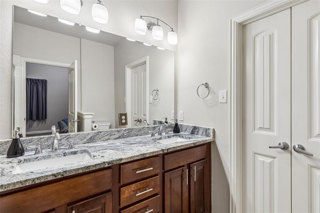 5500 Conch Train Road McKinney, TX 75070 - Photo 24 of 34 a bathroom with a granite countertop sink and a mirror