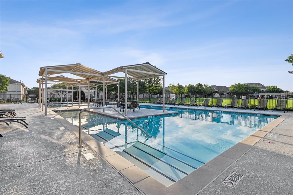 5500 Conch Train Road McKinney, TX 75070 - Photo 31 of 34 a view of a swimming pool with a table and chairs