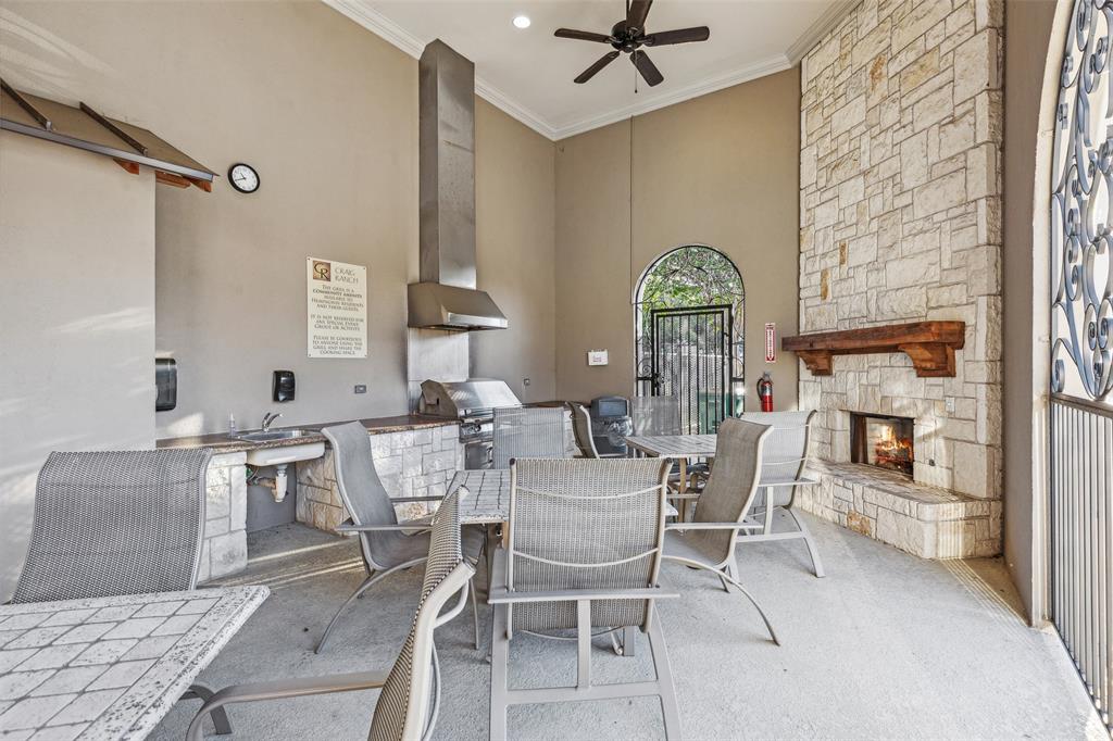 5500 Conch Train Road McKinney, TX 75070 - Photo 32 of 34 a view of a dining room with furniture and a fireplace