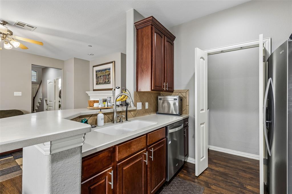 5500 Conch Train Road McKinney, TX 75070 - Photo 7 of 34 a kitchen with stainless steel appliances a sink cabinets and wooden floor