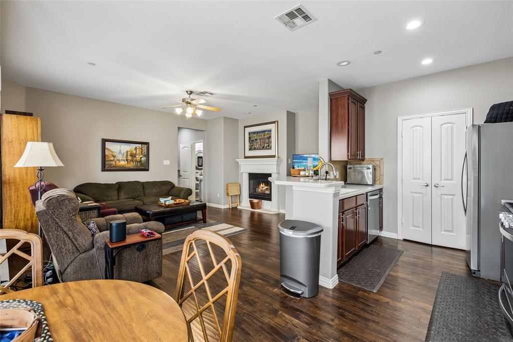 5500 Conch Train Road McKinney, TX 75070 - Photo 9 of 34 a living room with furniture a fireplace and a chandelier