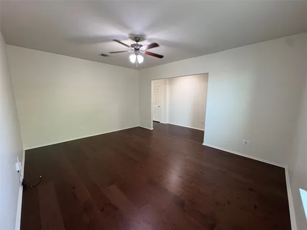 a kitchen with stainless steel appliances granite countertop a stove a sink dishwasher a refrigerator and a microwave oven with wooden floor