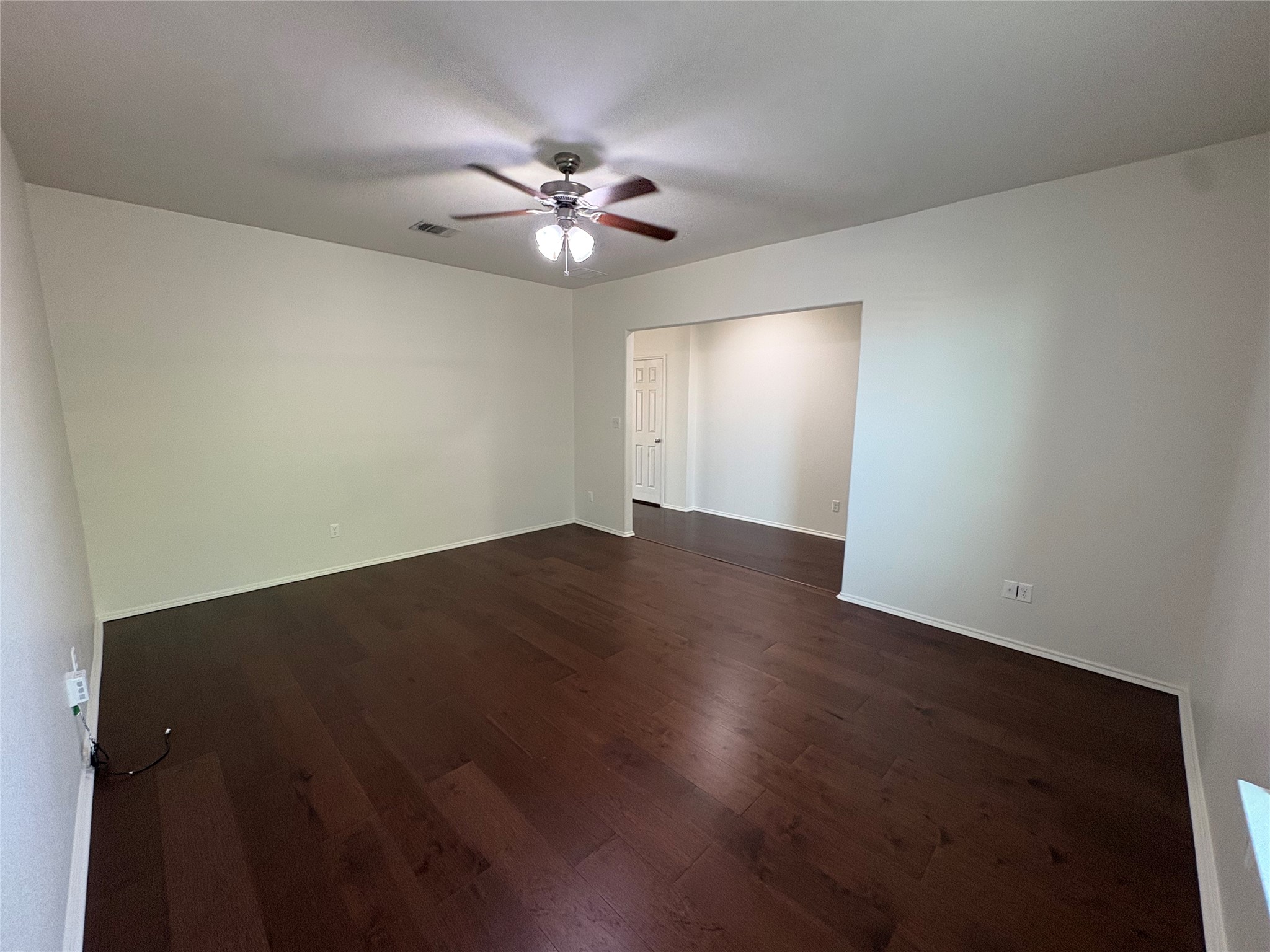 11617 Murron Drive Austin, TX 78754 - Photo 4 of 30 a view of a big room with wooden floor and chandelier fan