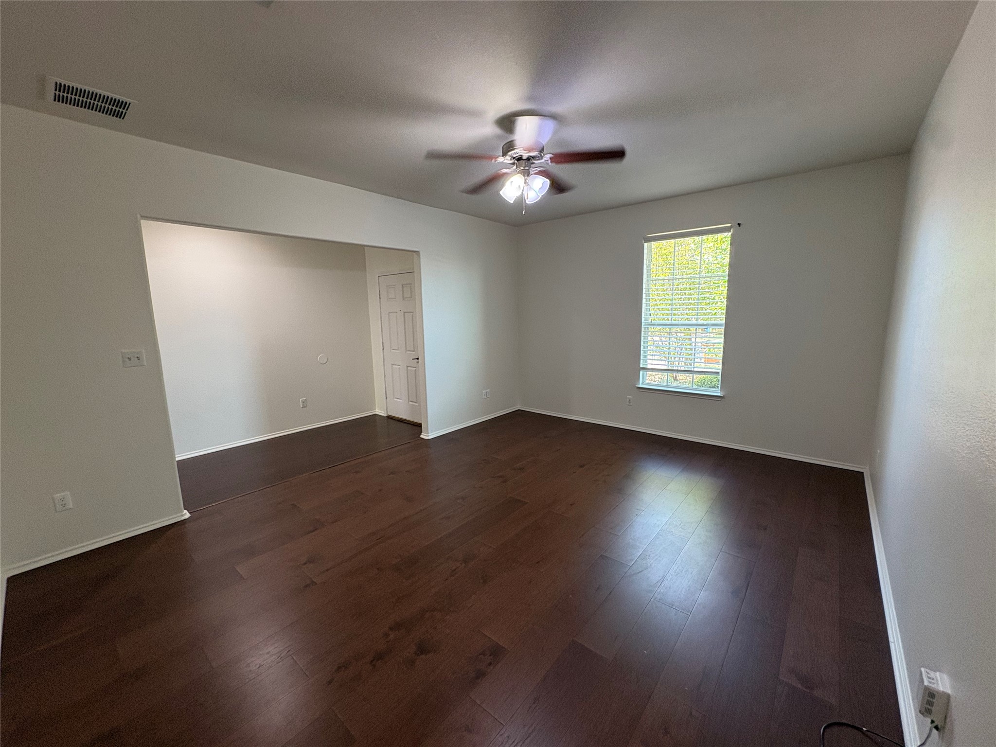 11617 Murron Drive Austin, TX 78754 - Photo 5 of 30 a view of an empty room with wooden floor and a window