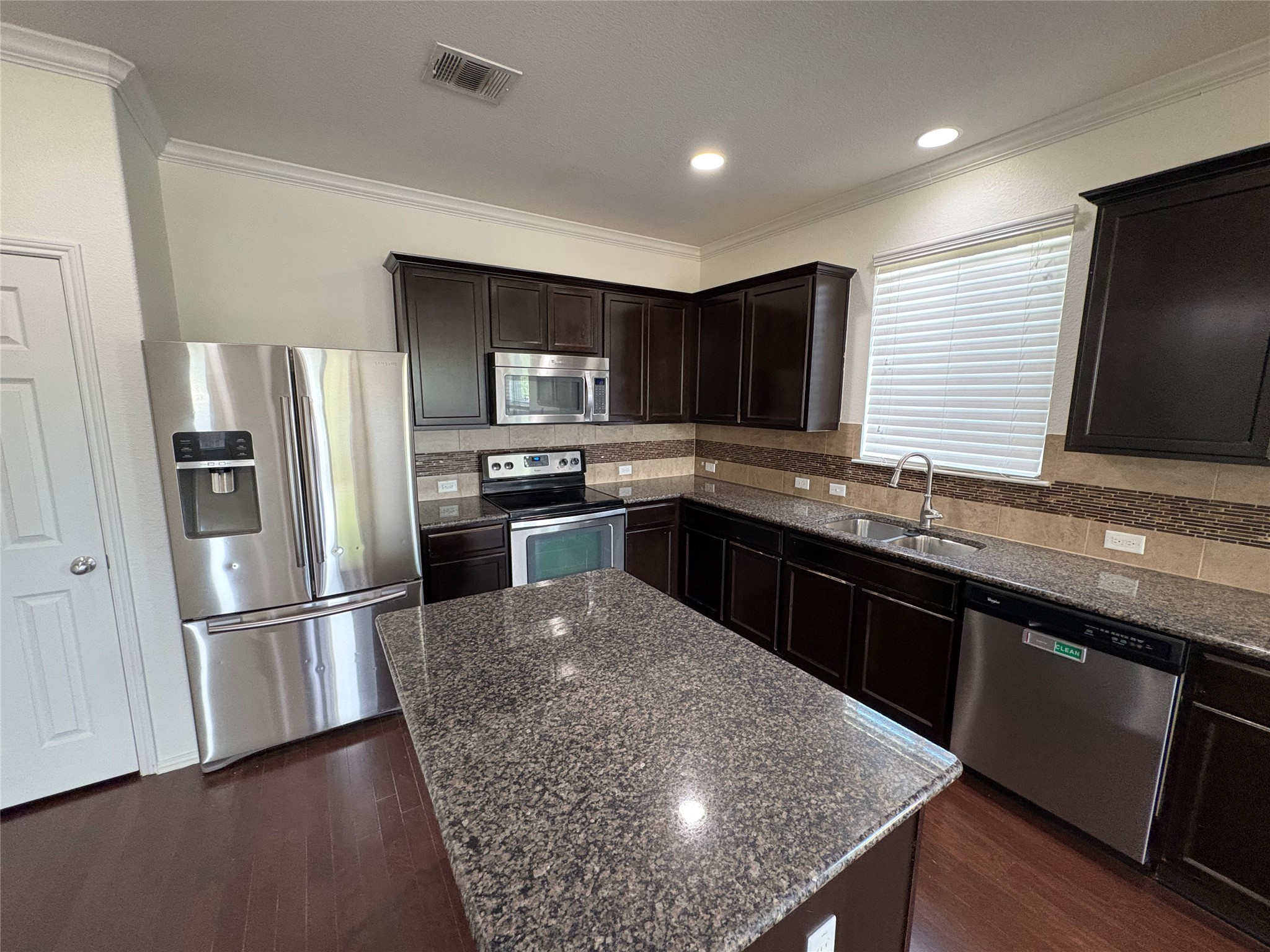 11617 Murron Drive Austin, TX 78754 - Photo 9 of 30 a kitchen with stainless steel appliances granite countertop a sink stove and refrigerator