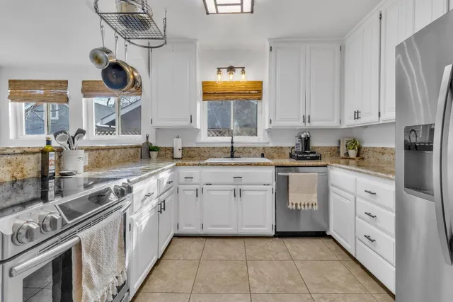 a view of kitchen with a sink and cabinets