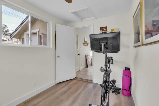 a view of a workspace with furniture and a window