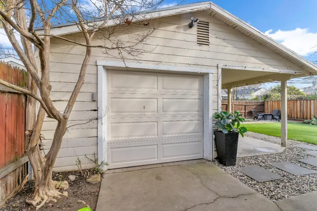 a view of a porch with furniture and garden