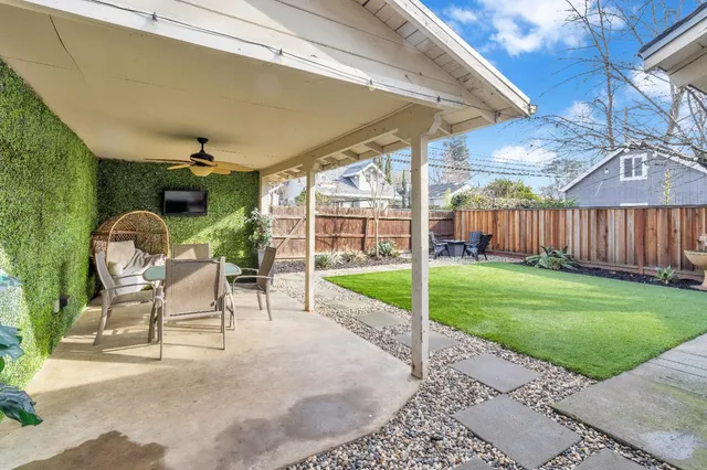 a view of a porch with furniture and a yard