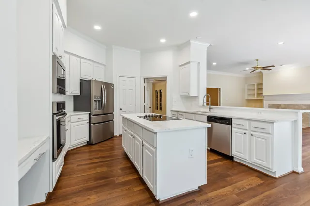 a view of a kitchen with wooden floor and a window