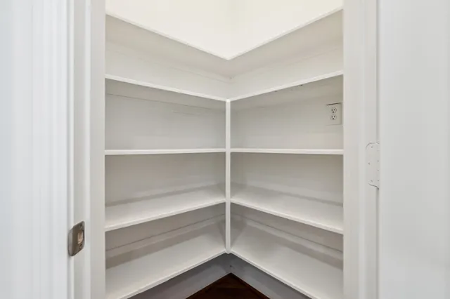 a living room with furniture fireplace and a large window