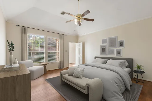 an empty room with wooden floor fan and windows