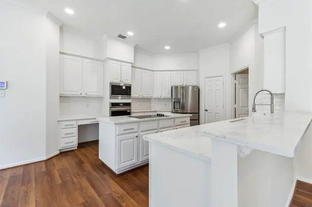 a kitchen with a sink stove and refrigerator