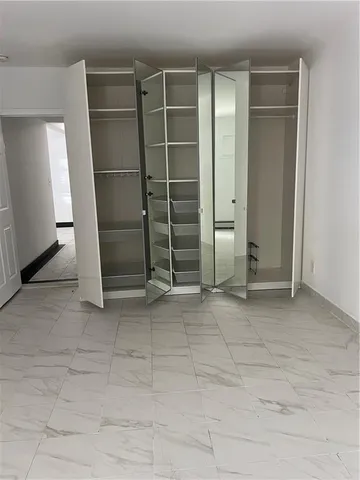 a white toilet sitting next to a bath tub