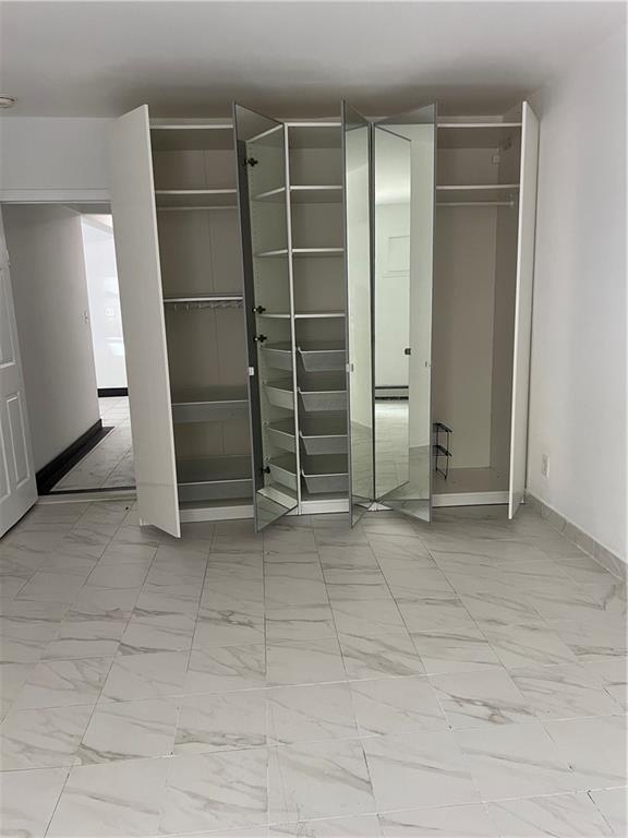 2955 Ocean Parkway, Unit BR Brooklyn, NY 11235 - Photo 4 of 6 a view of an empty room with empty shelves