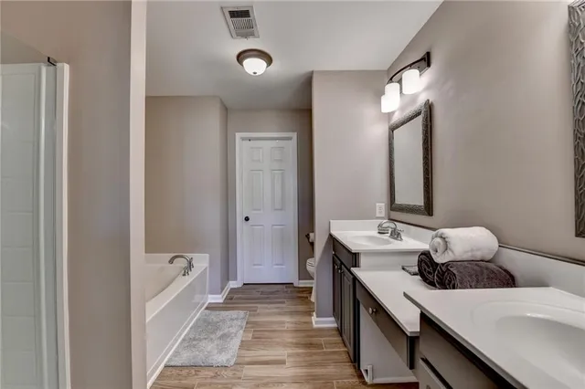 a en suite bathroom with a sink and a mirror