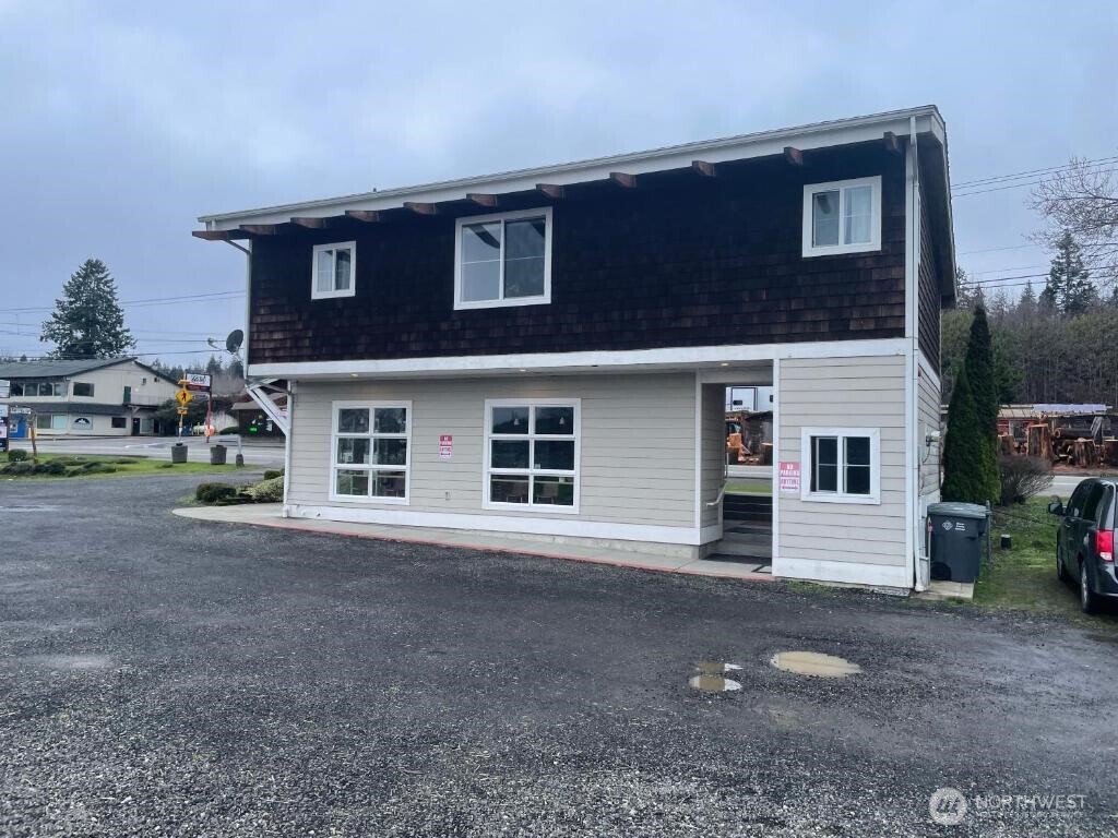 18350 Highway 3 Allyn, WA 98524 - Photo 1 of 18 a front view of a house with a yard