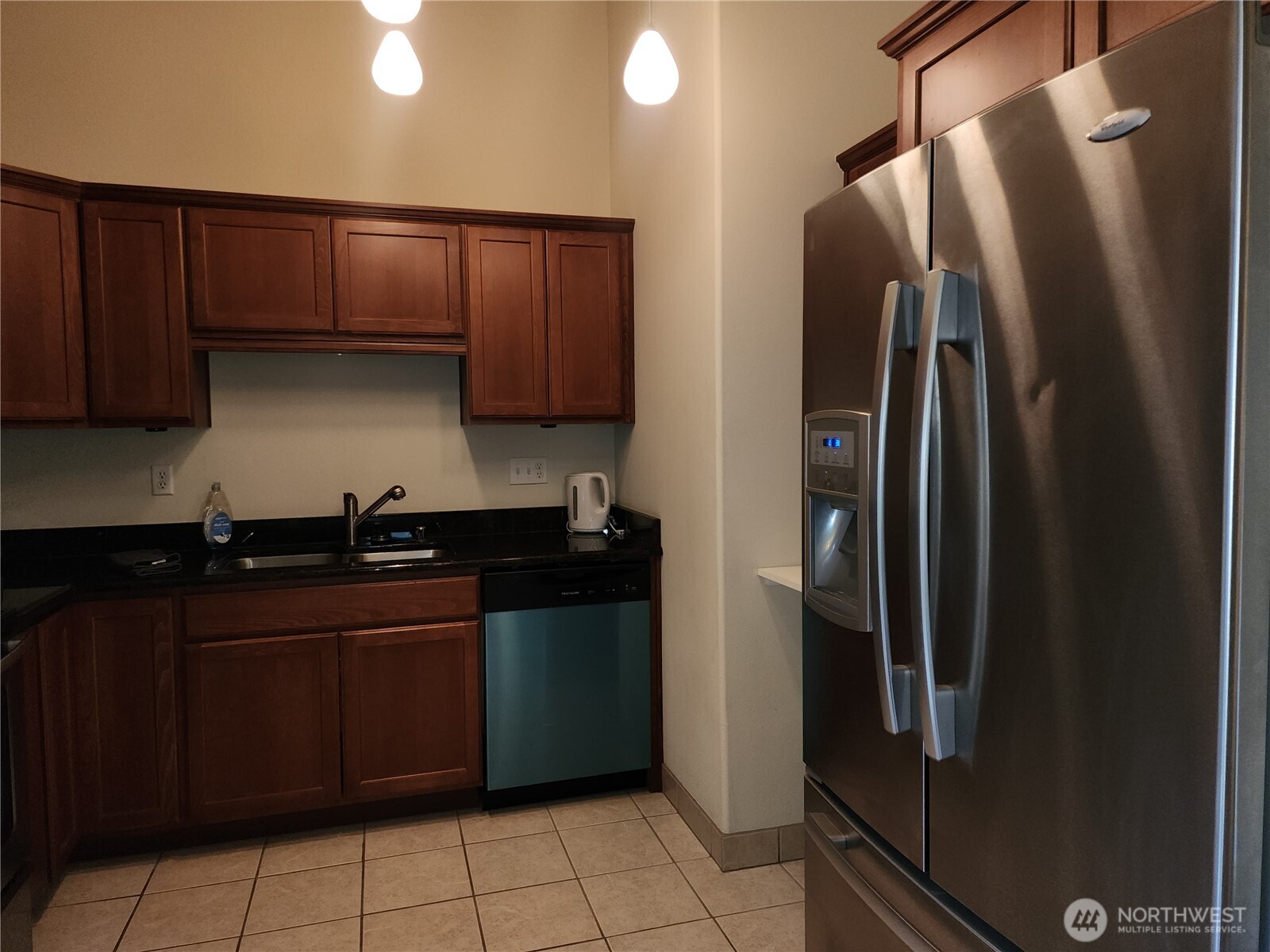 18350 Highway 3 Allyn, WA 98524 - Photo 11 of 18 a kitchen with stainless steel appliances granite countertop a refrigerator a sink and wooden cabinets