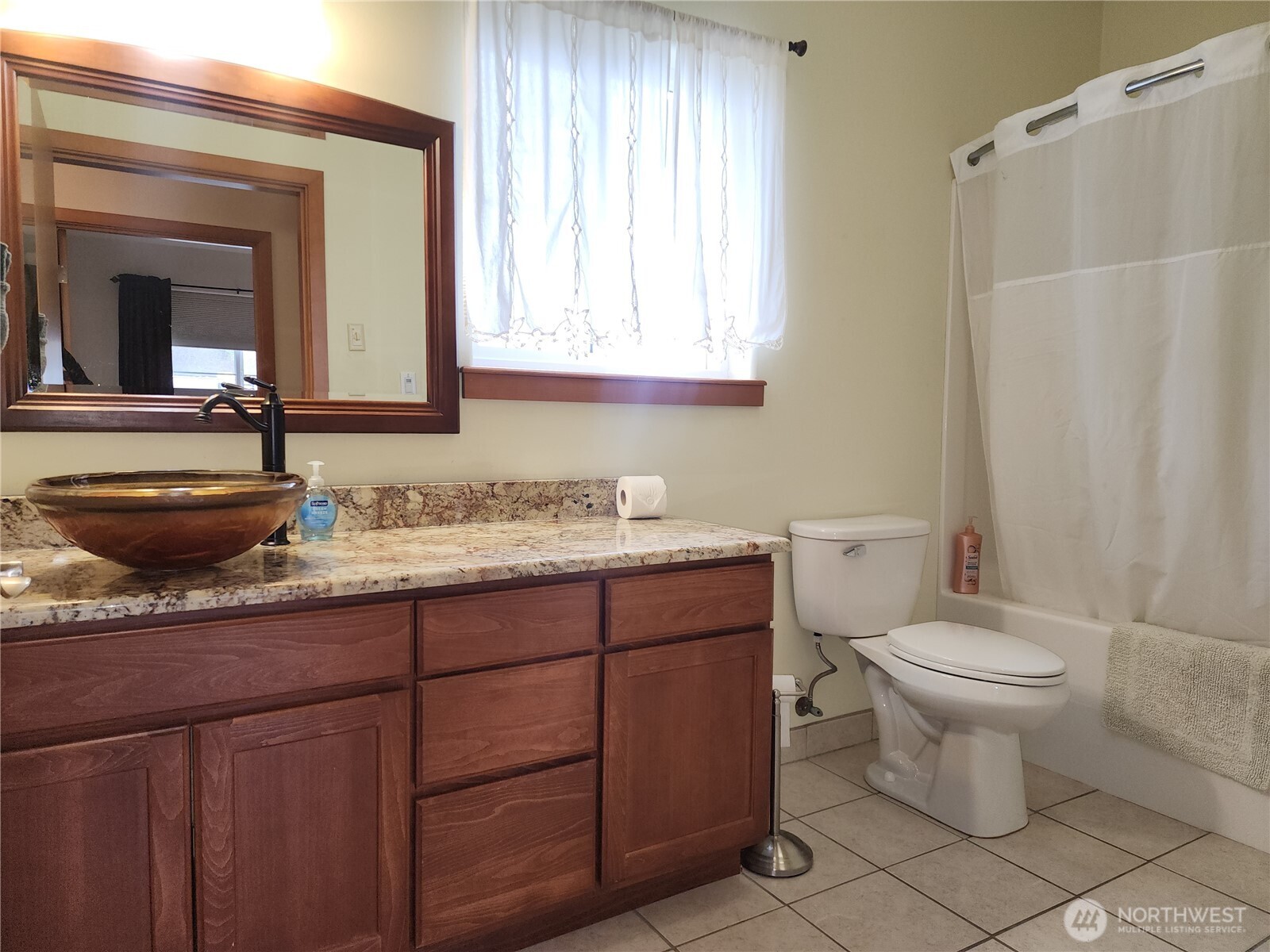18350 Highway 3 Allyn, WA 98524 - Photo 14 of 18 a bathroom with a granite countertop toilet a sink and a mirror