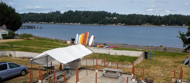 an aerial view of a house with pool lake view and mountain view