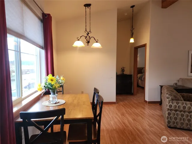 a view of a dining room with furniture window and wooden floor