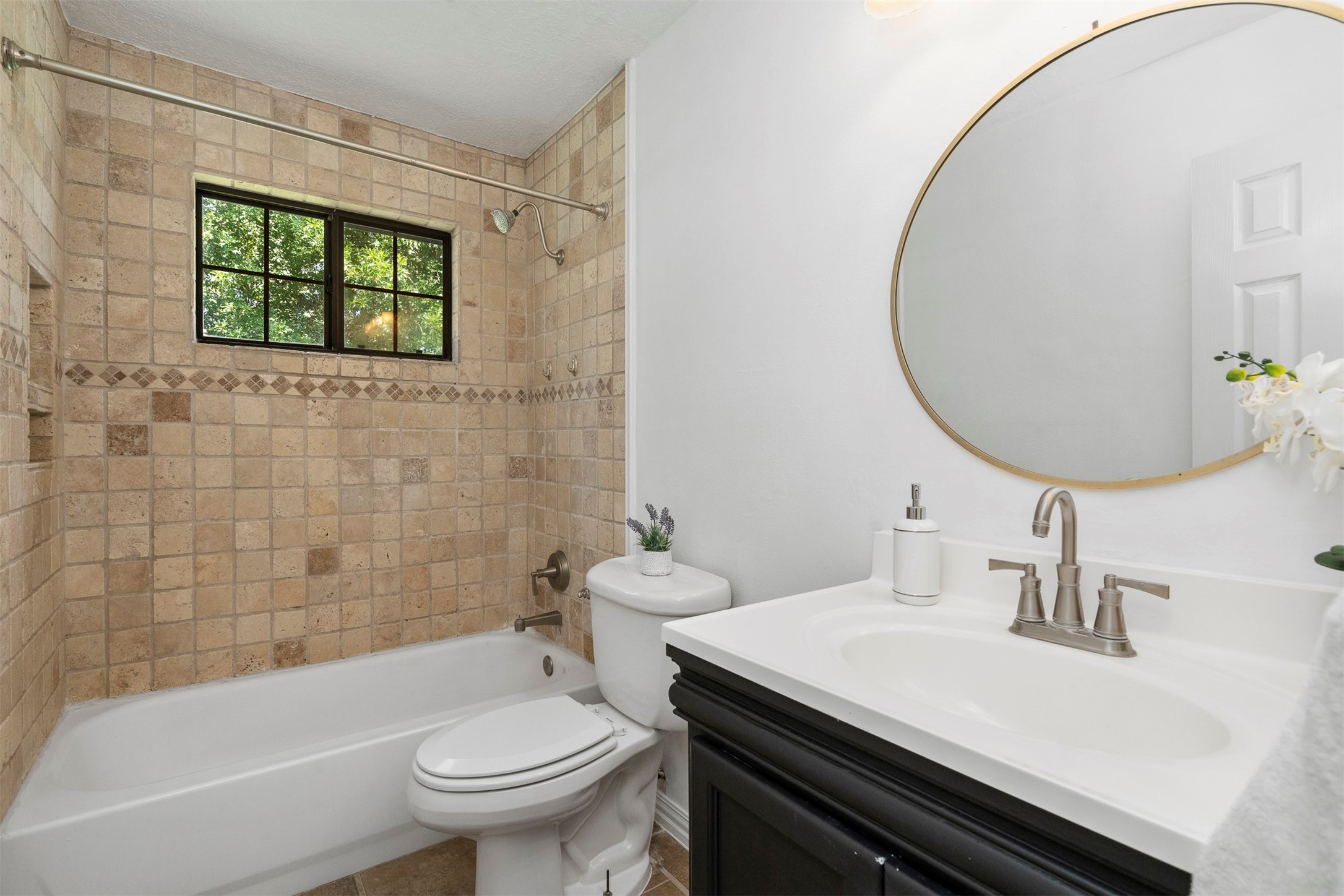 22835 Sherioaks Lane Spring, TX 77389 - Photo 8 of 12 The bathroom is conveniently located between the primary and secondary bedrooms.