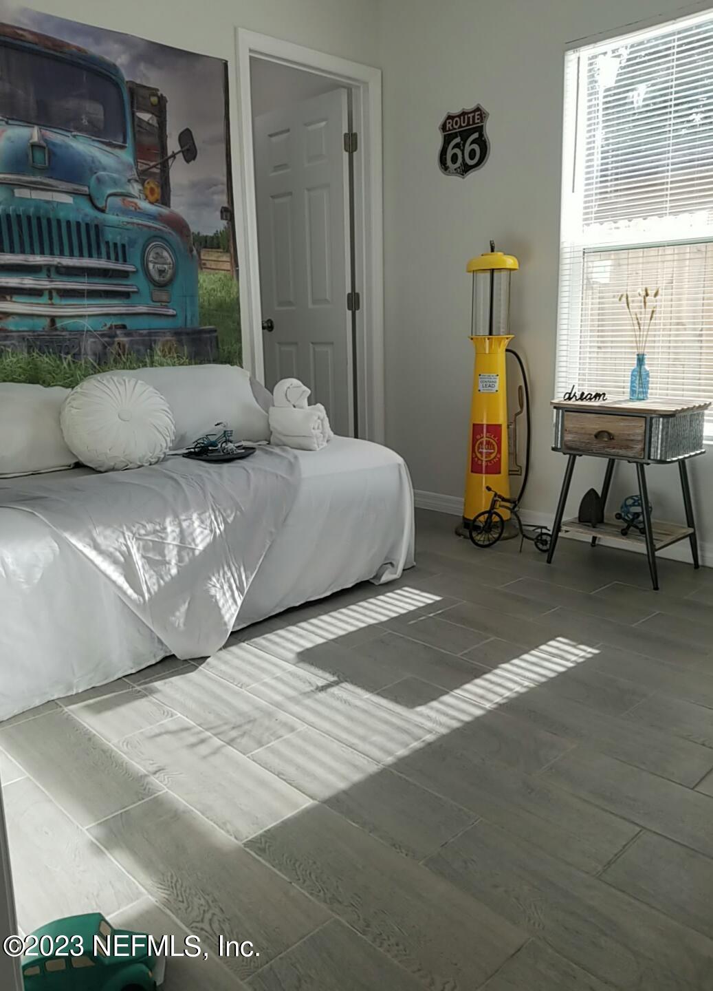 2116 Yulee Street Jacksonville, FL 32209 - Photo 9 of 12 a bedroom with a bed and a window