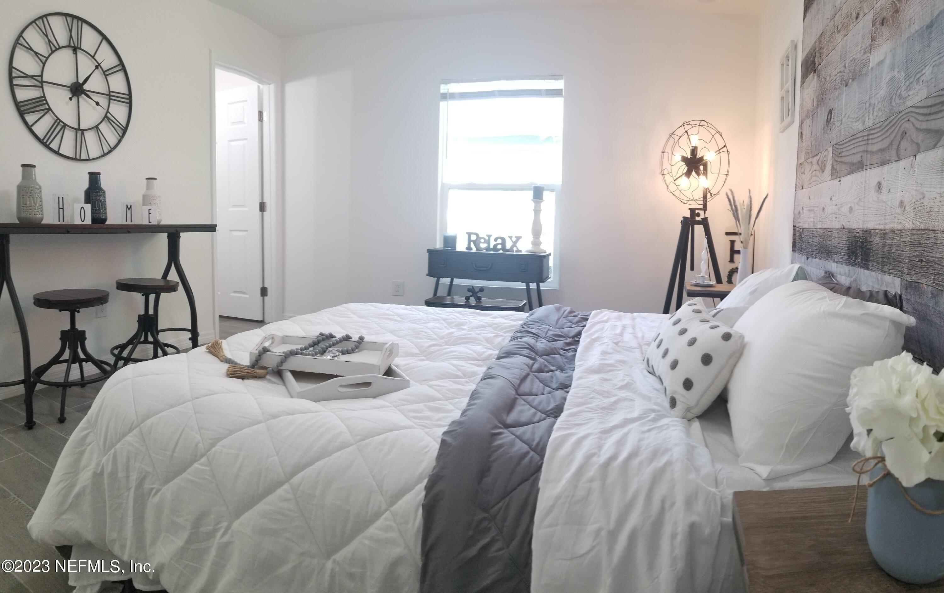 2116 Yulee Street Jacksonville, FL 32209 - Photo 10 of 12 a bedroom with a bed and a chandelier