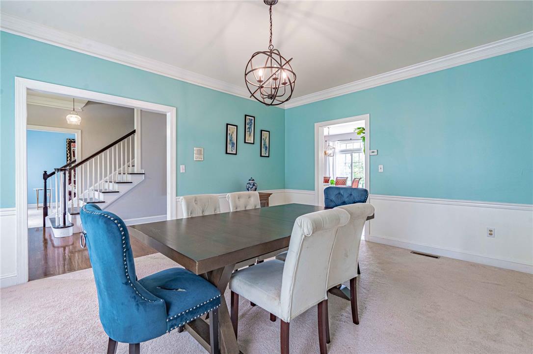 102 Sutton Road Easton, PA 18045 - Photo 16 of 83 Elegant crown molding and classic wainscoting define this formal dining space.