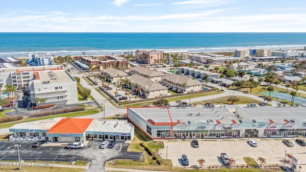 an aerial view of residential building and ocean