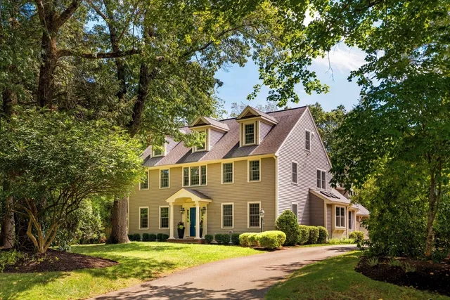 a front view of a house with a garden