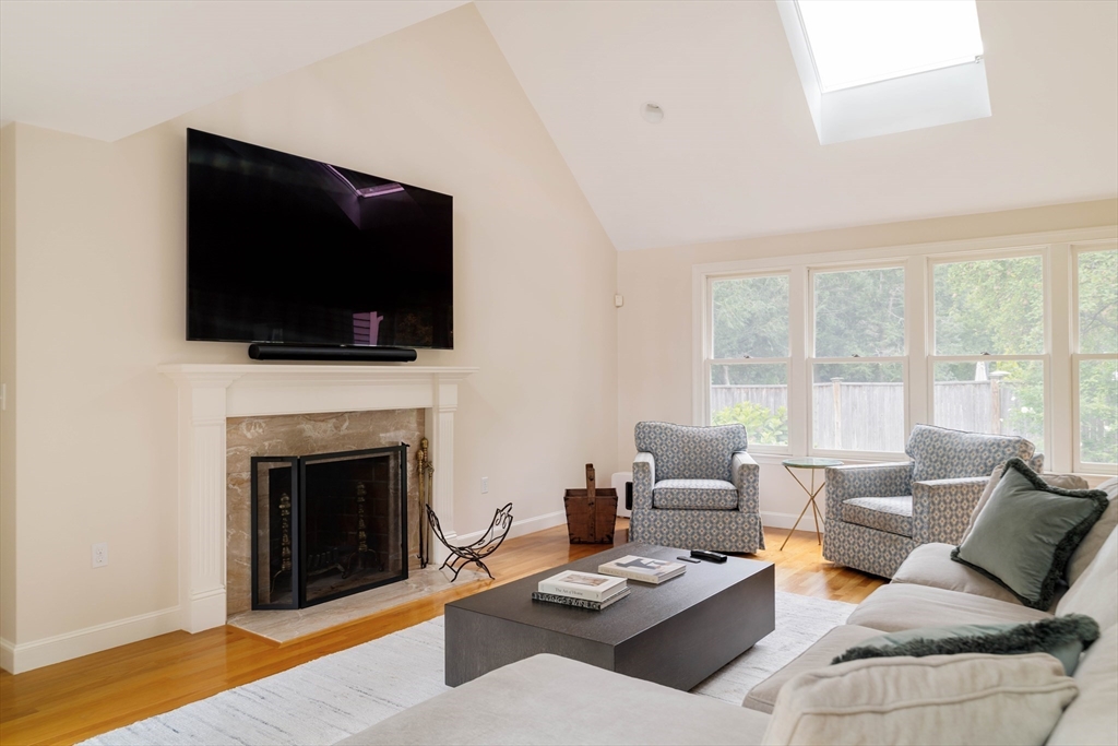 38 Fuller Brook Road Wellesley, MA 02482 - Photo 17 of 42 a living room with furniture a fireplace and a flat screen tv