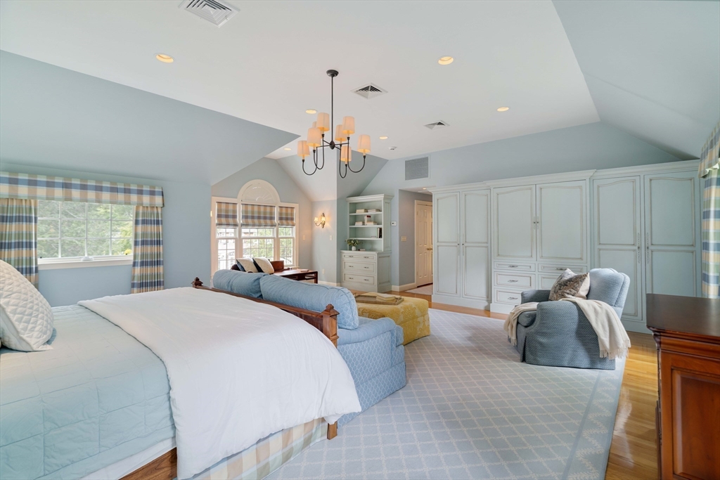38 Fuller Brook Road Wellesley, MA 02482 - Photo 23 of 42 a spacious bedroom with a bed chandelier and window