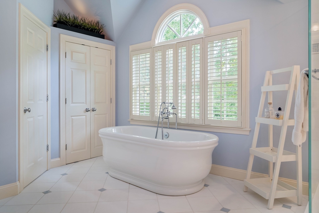 38 Fuller Brook Road Wellesley, MA 02482 - Photo 24 of 42 a white bath tub sitting in a bathroom next to a window