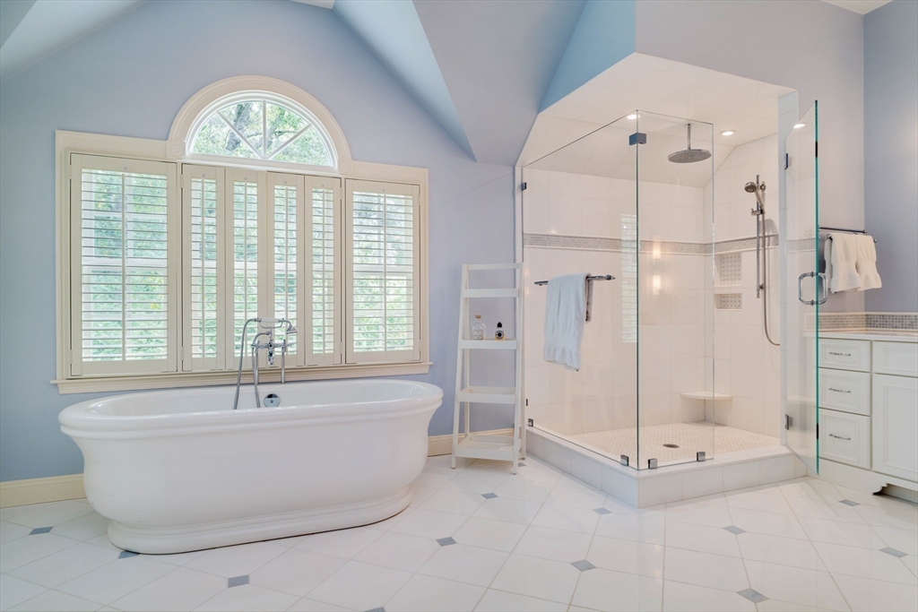 38 Fuller Brook Road Wellesley, MA 02482 - Photo 25 of 42 a bathroom with a tub a window and a shower