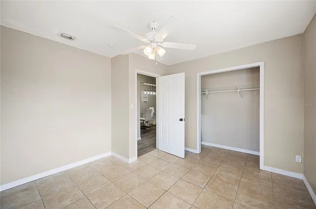 a view of an empty room with a ceiling fan