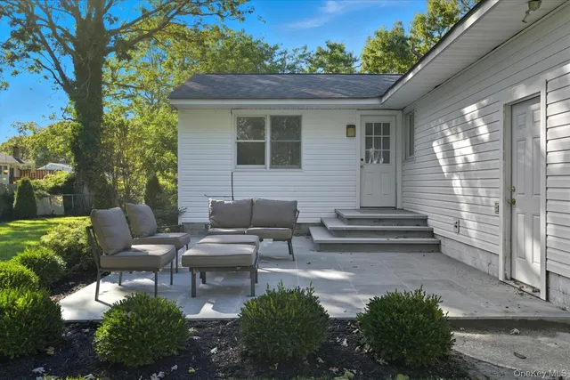a view of a patio with couches chairs and potted plants