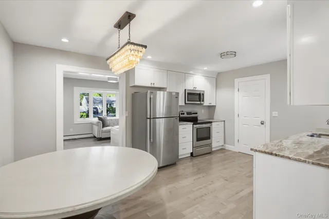 a kitchen with refrigerator and cabinets