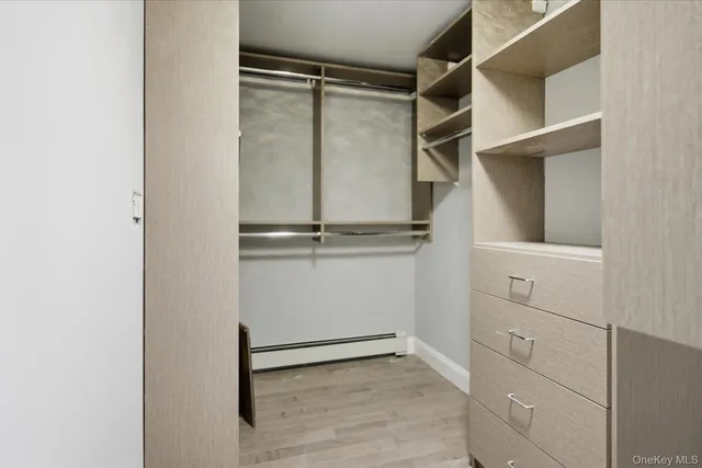 a view of walk in closet with empty racks